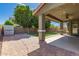 View of backyard featuring covered patio, pavers, a grassy area, and mature landscaping at 4059 E Mesquite St, Gilbert, AZ 85296