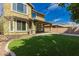 A covered patio and expansive lawn highlight the backyard of this lovely home at 4059 E Mesquite St, Gilbert, AZ 85296