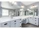 Bathroom boasts double sinks, white cabinetry, and a large mirror at 4059 E Mesquite St, Gilbert, AZ 85296