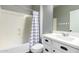 Bathroom featuring a shower-tub combo, white vanity, and neutral gray walls at 4059 E Mesquite St, Gilbert, AZ 85296