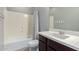 Bathroom featuring a shower-tub combo, white vanity, and neutral wall color at 4059 E Mesquite St, Gilbert, AZ 85296