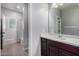 Bathroom featuring a single vanity with mirror, leading to a bath/shower area, offering a serene space at 4059 E Mesquite St, Gilbert, AZ 85296