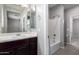 Bathroom area showcasing a vanity with a mirror and a view of a bath/shower area, providing functionality at 4059 E Mesquite St, Gilbert, AZ 85296