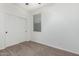 Bedroom with neutral carpet, bright white walls, and a window and closet at 4059 E Mesquite St, Gilbert, AZ 85296