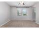 Bright bedroom with a ceiling fan, window, and plush carpeting, offering a comfortable living space at 4059 E Mesquite St, Gilbert, AZ 85296