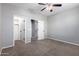 Bedroom featuring neutral walls and carpet, with doorways leading to a closet and other rooms at 4059 E Mesquite St, Gilbert, AZ 85296