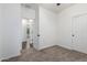 Neutral bedroom with carpet flooring, bright white walls, and doors to additional rooms at 4059 E Mesquite St, Gilbert, AZ 85296