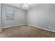 Neutral bedroom with a ceiling fan and a window providing natural light, carpeted flooring at 4059 E Mesquite St, Gilbert, AZ 85296