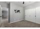 Neutral bedroom featuring carpet flooring, sliding closet doors, and a world map decoration at 4059 E Mesquite St, Gilbert, AZ 85296