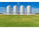 Exterior shot of four silver metal silos on a lush green lawn under a clear blue sky at 4059 E Mesquite St, Gilbert, AZ 85296