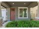 A welcoming front entrance with a solid door, sidelight window, and manicured shrubbery at 4059 E Mesquite St, Gilbert, AZ 85296