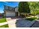 Two-story home featuring a two-car garage, lush front lawn, and mature shade tree at 4059 E Mesquite St, Gilbert, AZ 85296