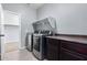 Laundry room with stainless steel washer and dryer with wooden cabinets and countertop at 4059 E Mesquite St, Gilbert, AZ 85296