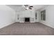 Living room featuring built-in shelves, a fireplace, neutral carpet, and large windows for ample natural light at 4059 E Mesquite St, Gilbert, AZ 85296