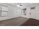 Bright living room featuring a ceiling fan, dark wood floors and neutral carpet at 4059 E Mesquite St, Gilbert, AZ 85296