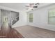 Bright living room with neutral carpet, ceiling fan, and a staircase at 4059 E Mesquite St, Gilbert, AZ 85296