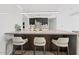 Stylish kitchen island featuring modern bar stools, sleek countertop, and minimalist lighting at 7157 E Rancho Vista Dr # 4001, Scottsdale, AZ 85251