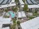 Scenic aerial view of the condo complex featuring pool, spa, landscaping, and parking at 7625 E Camelback Rd # A108, Scottsdale, AZ 85251