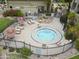 Aerial view of the relaxing community hot tub area with chairs, tables, and mature landscaping at 7625 E Camelback Rd # A108, Scottsdale, AZ 85251