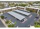 Aerial shot of the property's parking area with covered parking spaces and mature landscaping at 7625 E Camelback Rd # A108, Scottsdale, AZ 85251