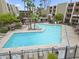 View of the inviting community pool and lounge area with ample seating and shade at 7625 E Camelback Rd # A108, Scottsdale, AZ 85251