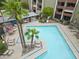 A clear aerial view of the community pool area featuring lounge chairs and palm trees at 7625 E Camelback Rd # A108, Scottsdale, AZ 85251