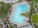 Aerial view of a community pool surrounded by lush landscaping and lounge chairs at 7625 E Camelback Rd # A108, Scottsdale, AZ 85251