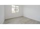 Bedroom features wood-look tile flooring, white walls, and a window to let in natural light at 1246 E Penedes Dr, Gilbert, AZ 85298