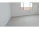 Bedroom featuring neutral carpet, white walls, and a window to let in natural light at 1246 E Penedes Dr, Gilbert, AZ 85298