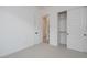 Bright bedroom featuring neutral carpet, closet, ensuite bathroom, and contemporary design at 1246 E Penedes Dr, Gilbert, AZ 85298