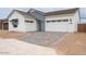 Charming single-Gathering home featuring a three-car garage and well-manicured, desert-style landscaping at 1246 E Penedes Dr, Gilbert, AZ 85298