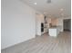 Open-concept kitchen features white cabinets, an island, and stainless steel appliances at 1246 E Penedes Dr, Gilbert, AZ 85298