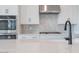 Contemporary kitchen featuring stainless steel appliances, black faucet, and gray geometric backsplash at 1246 E Penedes Dr, Gilbert, AZ 85298