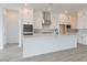 Modern kitchen with white cabinets, stainless steel appliances, a stylish backsplash, and a large island at 1246 E Penedes Dr, Gilbert, AZ 85298
