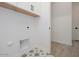 Laundry room featuring patterned tile flooring, white cabinets, and a convenient utility sink at 1246 E Penedes Dr, Gilbert, AZ 85298