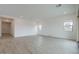 Bright open living room featuring wood-look tile flooring, recessed lighting, and white walls at 1246 E Penedes Dr, Gilbert, AZ 85298