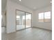 Well-lit room featuring wood-look flooring, recessed lighting, a sliding door, and backyard access at 1246 E Penedes Dr, Gilbert, AZ 85298