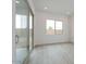 Bright, empty living room with wood-look flooring, recessed lighting, and sliding glass door to backyard at 1246 E Penedes Dr, Gilbert, AZ 85298