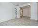Living room featuring wood-look tile flooring and white walls leading to other rooms at 1246 E Penedes Dr, Gilbert, AZ 85298