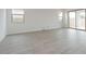 Bright living room featuring wood-look tile flooring, recessed lighting, and lots of natural light at 1246 E Penedes Dr, Gilbert, AZ 85298