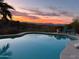 Inviting pool with desert views and lounge chairs under a breathtaking sunset sky at 15730 E Eagle Crest Rd, Fountain Hills, AZ 85268