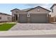 Charming single-Gathering home featuring a paved driveway, two-car garage and appealing stone accents at 19323 W San Juan Ave, Litchfield Park, AZ 85340