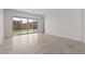 Bright living area with neutral tile flooring and sliding glass doors that provide access to the backyard at 19323 W San Juan Ave, Litchfield Park, AZ 85340