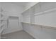 Spacious walk-in closet features custom shelving, multiple rails, and carpeted floors at 19323 W San Juan Ave, Litchfield Park, AZ 85340