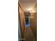 The hallway has beige carpet, wall-mounted lamps and wood-paneled walls at 25 S 102Nd St # 79, Mesa, AZ 85208