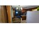 A kitchen with wooden cabinets, white refrigerator, and table with chairs at 25 S 102Nd St # 79, Mesa, AZ 85208
