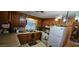 An L-shaped kitchen features wooden cabinets, white appliances, and a window above the sink at 25 S 102Nd St # 79, Mesa, AZ 85208