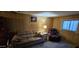 Cozy living room featuring a plush sofa, a leather recliner, and a bright window at 25 S 102Nd St # 79, Mesa, AZ 85208