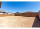 Spacious backyard with block wall and a dirt surface, perfect for landscaping and outdoor activities at 5011 W Hardtack Trl, Laveen, AZ 85339