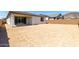 Expansive backyard space with a covered patio and block wall, perfect for outdoor entertaining and relaxation at 5011 W Hardtack Trl, Laveen, AZ 85339